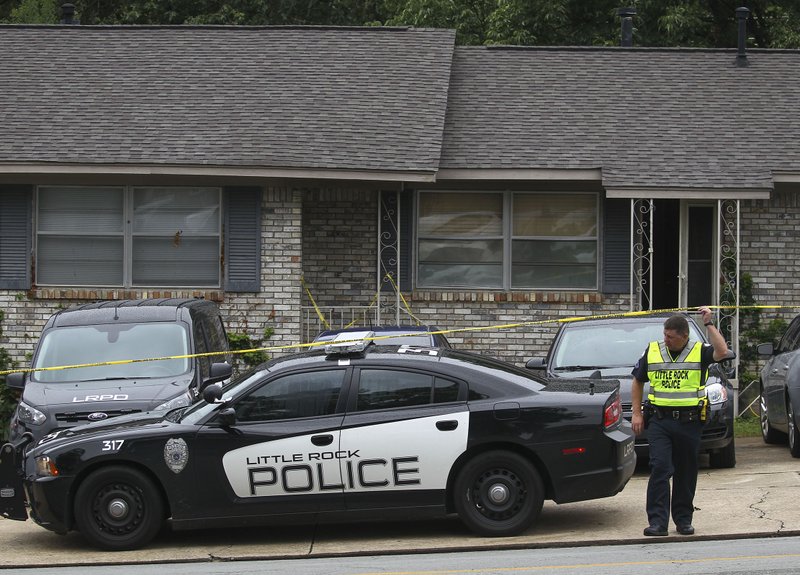 Little Rock police and crime scene officers remove drugs, money and evidence while investigating a homicide at 10915 Mara Lynn Road Friday morning.