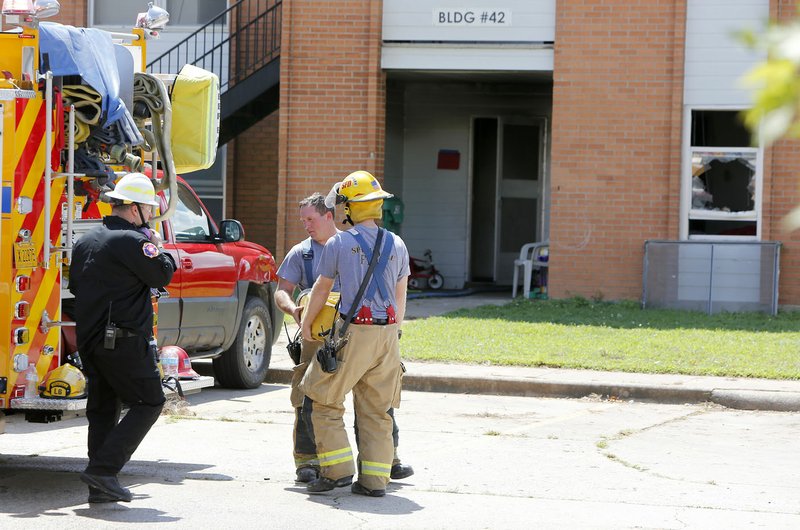 Springdale Firefighters collect equipment and continue an investigation following a structure fire Friday in building 42 on Applegate Drive at the Applegate Apartments. Four people were transported to a hospital, according to the Springdale Fire Department. Firefighters went to Applegate Drive at 11:27 a.m. for reports of a fire in a downstairs apartment unit in building No. 42, according to dispatch logs. The complex is about half a mile from Jones Elementary School.