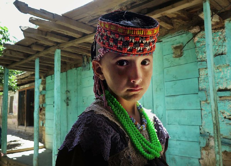 A girl wears traditional dress in the village of Bumberet in the Kalash Valley in Pakistan’s northwestern Khyber Pakhtunkhwa province. 