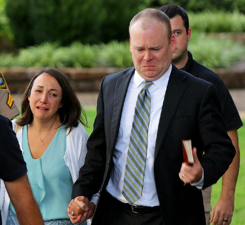 Garland County Circuit Judge Wade Naramore and his wife, Ashley, leave the courthouse Friday in Hot Springs after he was found innocent in the death of his son. Naramore wept as he heard the verdict. 