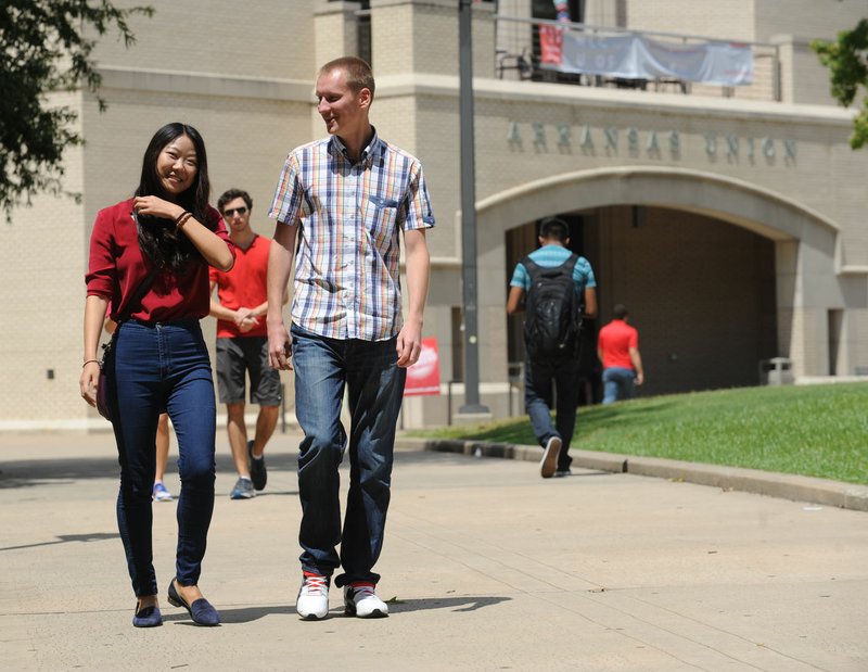 Students walk Friday through the Union Mall on the University of Arkansas campus in Fayetteville.
