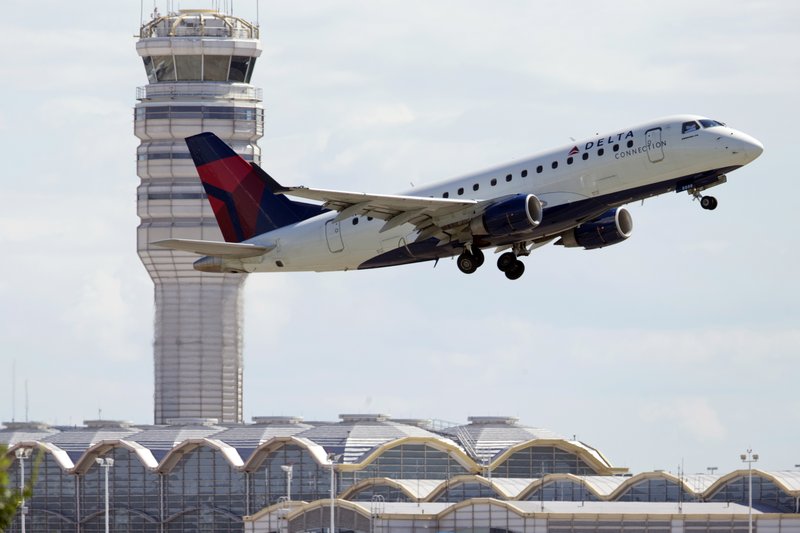 In this July 28, 2014 file photo, a Delta Air Lines jet takes off from Ronald Reagan Washington National Airport in Arlington, Va.  
