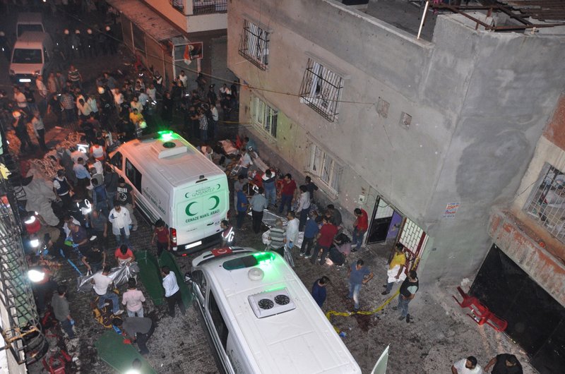 People carry dead bodies into ambulances after an explosion in Gaziantep, Turkey, early Sunday. A bomb attack targeting an outdoor wedding party killed several people and wounded dozens. Deputy Prime Minister Mehmet Simsek said the "barbaric" attack in Gaziantep, near the border with Syria, on Saturday appeared to be a suicide bombing.