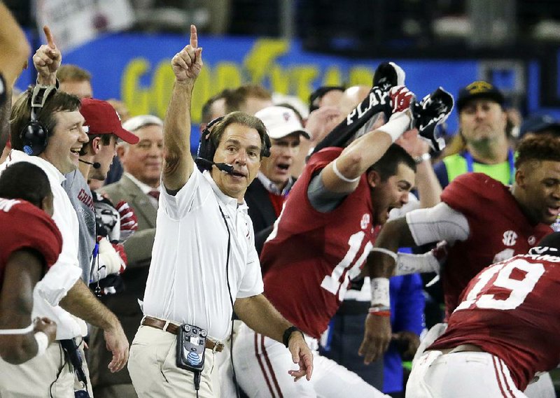 FILE - In this Dec. 31, 2015, file photo, Alabama head coach Nick Saban and team take the field at the end of the Cotton Bowl NCAA college football semifinal playoff game against Michigan State, in Arlington, Texas. Alabama is No. 1 in The Associated Press preseason Top 25 for the third time under coach Nick Saban as the Crimson Tide attempts to win a second straight national title and fifth in eight seasons.  (AP Photo/LM Otero, File)