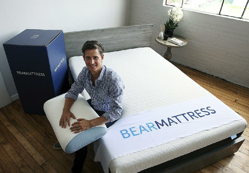 Scott Paladini, CEO of Bear Mattress, sits with a sample Bear Mattress, a newly designed pillow and a shipping box in the company showroom in Hoboken, N.J., earlier this month.