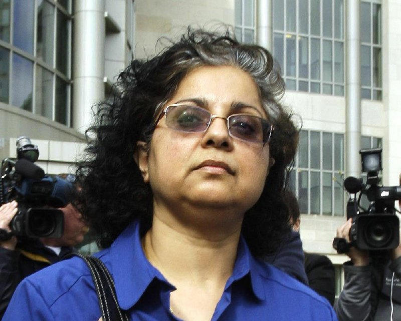 Sangeeta Mann walks past the media as she leaves the federal courthouse in Little Rock, Ark., after being sentenced Monday, Feb. 28, 2011, to a year in prison after being convicted of obstruction. 