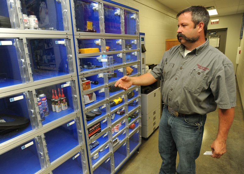 Mike Rogers, agriculture teacher at Siloam Springs High School, talks Friday about the equipment checkout system used for students at the Career Academy at Siloam Springs High School. The system allows for easy restocking of supplies and works in a similar way to systems used by local employers.