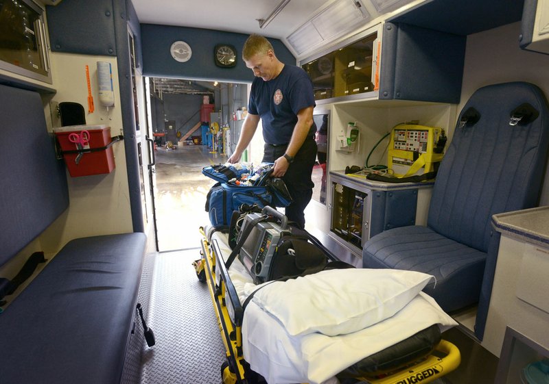 Jon Wright, Bella Vista firefighter/EMT, performs a routine equipment inventory in the department's Medic 5 ambulance Thursday at Bella Vista Fire Station 1.