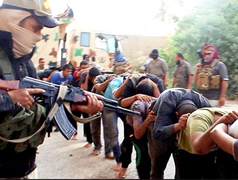 This image posted online by Islamic State militants on June 14, 2014 shows Iraqi cadets captured by IS moments before they were killed in Tikrit, Iraq. 