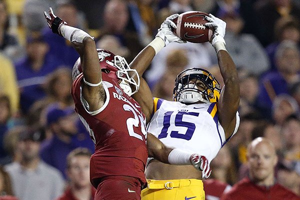 In this Nov. 14, 2015, file photo, LSU wide receiver Malachi Dupre (15) pulls in a pass over Arkansas defensive back Jared Collins (29) in the second half of an NCAA college football game, in Baton Rouge, La. (AP Photo/Gerald Herbert, File)