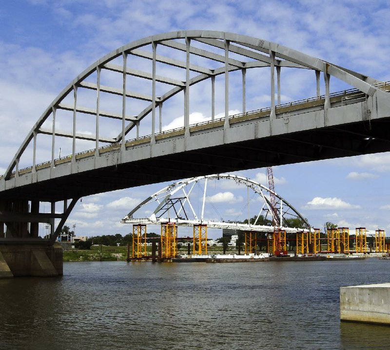 One of the new Broadway Bridge arches is being built on barges near the riverbank in North Little Rock just down from the current, 93-year-old bridge. That will enable it to be floated into its permanent position, lessening the time the span will have to be closed to the 25,000 motorists who cross it daily.