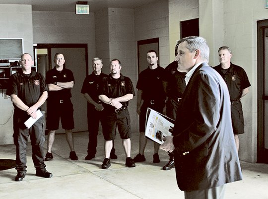 The Sentinel-Record/Colbie McCloud FIRE GRANT: U.S. Rep. Bruce Westerman, R-District 4, right, presents a Federal Emergency Management Agency Assistance to Firefighters Grant of $409,091 to the Hot Springs Fire Department Monday at the Central Fire Station to purchase a live fire training simulator.