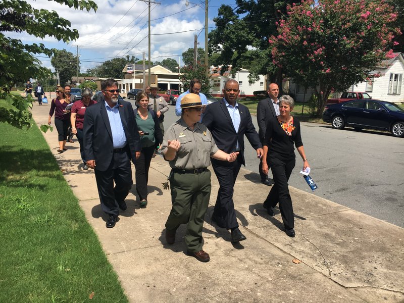 National Park Service Ranger Jodi Morris leads U.S. Secretary of the Interior Sally Jewell, front right, and U.S. Secretary of Transportation Anthony Foxx, front middle, on a tour of Central High School in Little Rock on Tuesday, Aug. 23, 2016. 