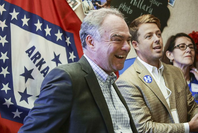 Democratic vice presidential candidate Tim Kaine, visiting Tuesday with Evan Tanner (second from right) and other Clinton campaign workers and volunteers, recalled spending spring breaks canoeing Arkansas streams while growing up in Kansas City.