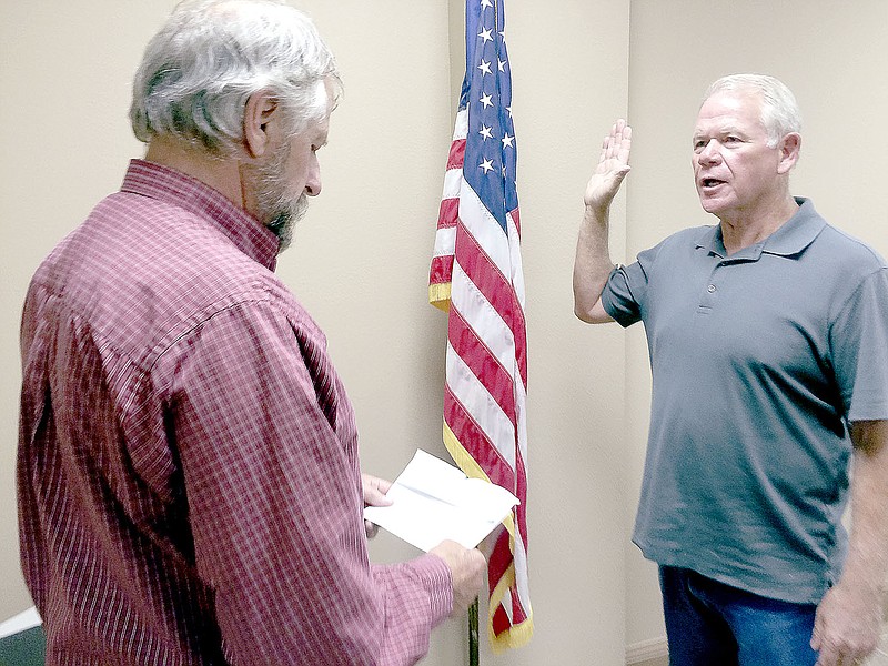 Terry Warren, of Garfield, repeats the oath of office administered by Garfield Mayor Gary Blackburn Aug. 9 after the City Council elected him to fill a vacant council seat.