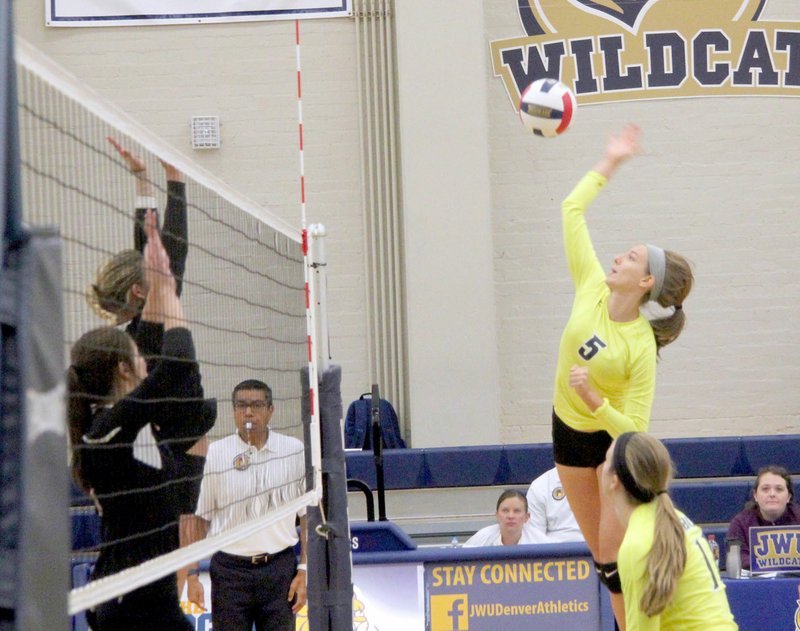 Photo courtesy of Johnson and Wales University John Brown freshman middle hitter Jessica Meyer, No. 5, goes up for a kill during one of JBU&#8217;s two matches on Saturday in the Johnson and Wales (Colo.) Invitational in Denver.