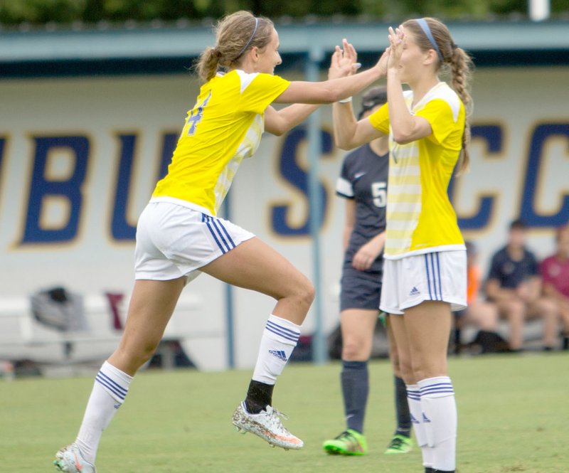 Photo courtesy of JBU Sports Information John Brown sophomores Anne Metz, left, and Aspen Robinson celebrate after Metz scored a goal in the 58th minute of the Golden Eagles&#8217; 6-0 win against Lyon on Saturday at Alumni Field.