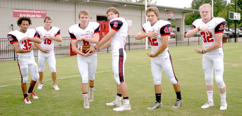 MARK HUMPHREY ENTERPRISE-LEADER Farmington senior Jake Oskey, shown handing off, is competing for the starting quarterback job. He has plenty of runningbacks to hand off to including (from left): sophomore Dimariae Donovan, junior Caleb Williams, junior Javon Jowers, junior Jared Oskey and sophomore Reid Turner. Tuesday&#8217;s Red and White game showcased the Cardinals for their fans.