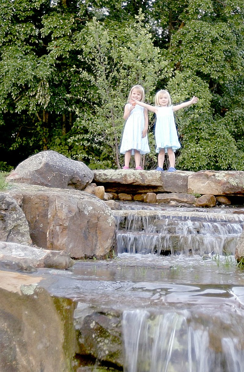 Photo submitted Two cuties stand on top of a waterfall at Simple Pleasures, a catering and events center that&#8217;s hosting Hamburgers and Heroes on Sept. 18.