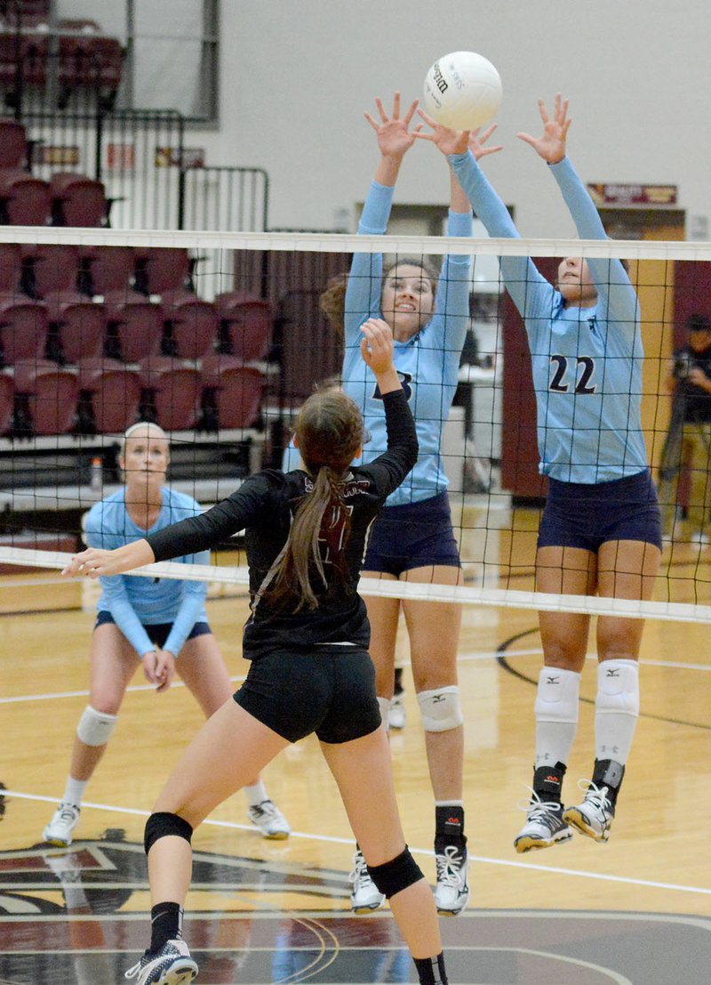 Bud Sullins/Special to the Herald-Leader Springdale Har-Ber senior middle hitters Jaden Williams, middle, and Klaire Trainor attempt to block the hit of Siloam Springs sophomore Chloe Price during Monday&#8217;s season-opening match at Panther Activity Center. The Lady Wildcats swept the Lady Panthers 3-0.