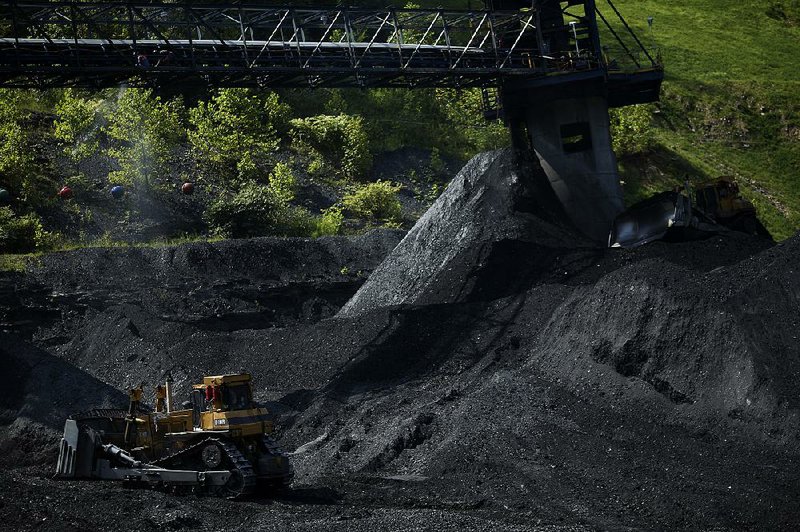 A bulldozer moves coal at an Alpha Natural Resources Inc. coal preparation plant in Logan County near Yolyn, W.Va., in this 2015 file photo. 