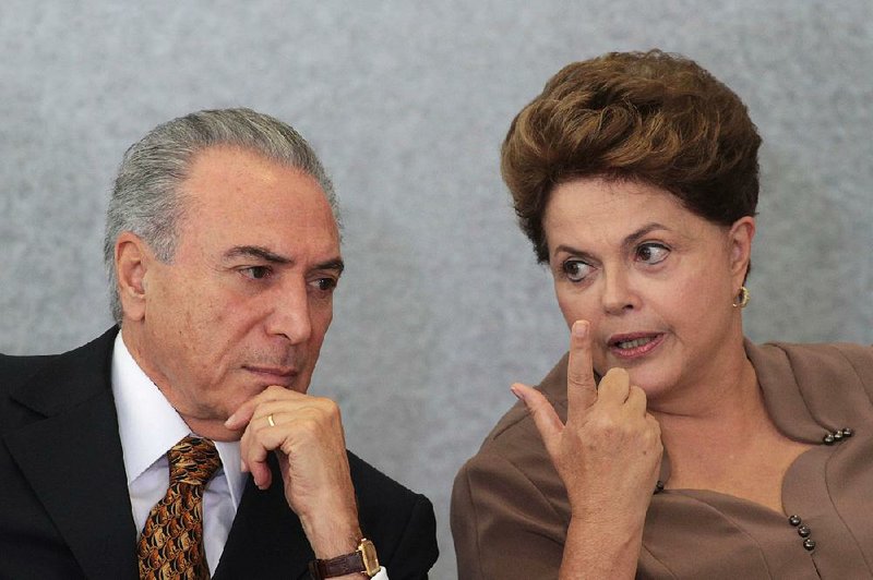 Brazil’s President Dilma Rousseff talks with Vice President Michel Temer during a ceremony in Brasilia in April. Rousseff, who was suspended in May and replaced on an interim basis by Temer, faces a trial to remove her permanently from office.