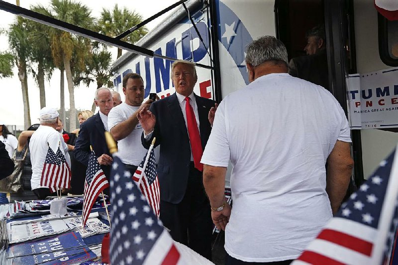 Republican presidential candidate Donald Trump visits campaign volunteers Wednesday before speaking at a rally in Tampa, Fla.