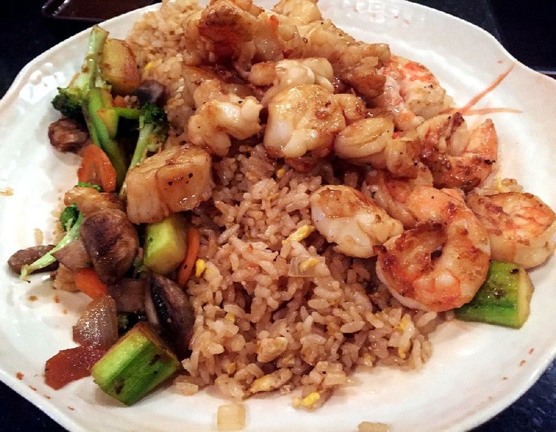 The Samurai Seafood Feast, served here with fried rice and vegetables, includes shrimp, scallops and lobster tail. 