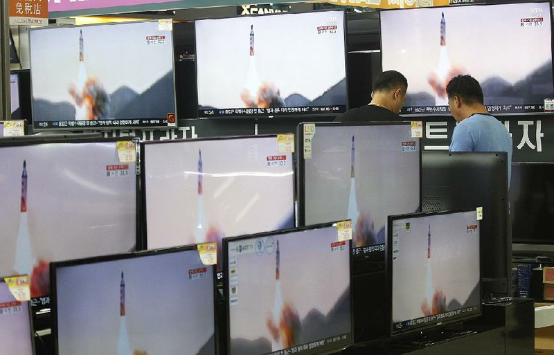 Televisions in an electronics store in Seoul replay footage Wednesday of North Korea’s purported underwater launch of a ballistic missile that South Korean officials say flew about 310 miles from its launch site.