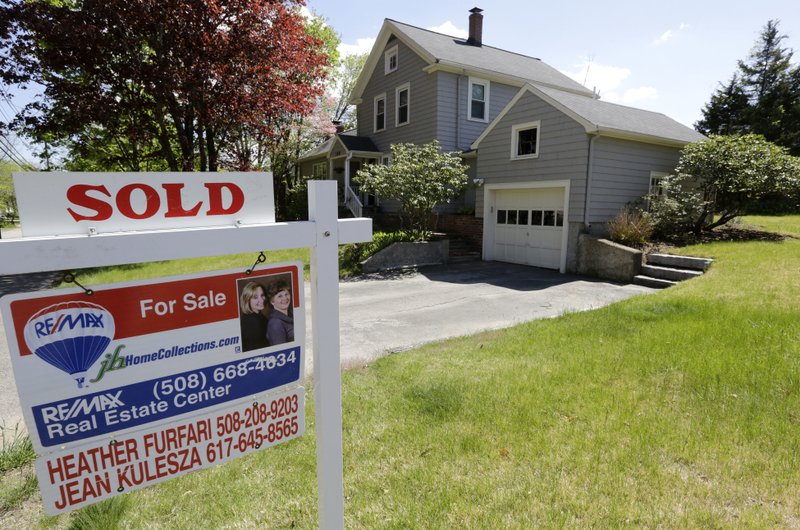 = This Wednesday, May 18, 2016, file photo shows a "Sold" sign in front of a house in Walpole, Mass. 