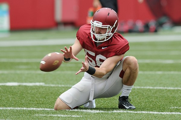 Arkansas holder Matt Emrich goes through practice Saturday, Aug. 20, 2016, at Razorback Stadium in Fayetteville. 