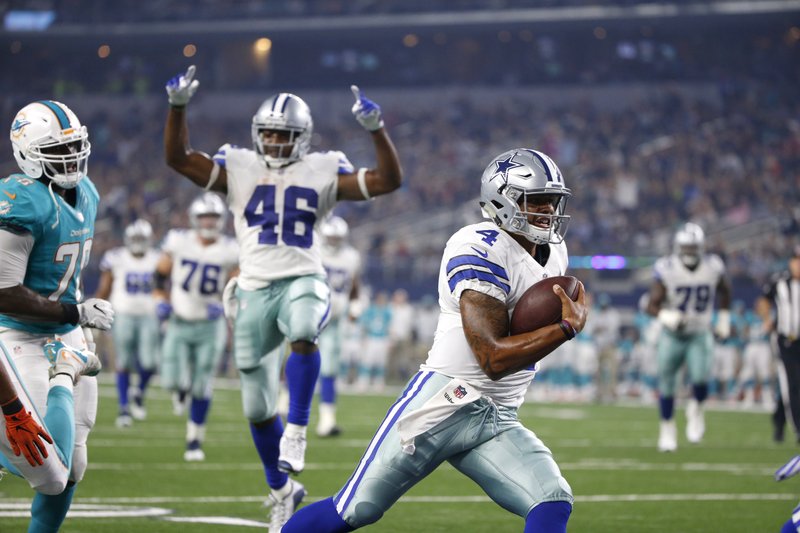 The Associated Press RAVES FOR ROOKIE: Teammate Alfred Morris (46) signals a touchdown scored by rookie quarterback Dak Prescott (4) as the Dallas Cowboys defeat the Miami Dolphins in an exhibition game last week. The Cowboys, 1-1 in preseason, play at Seattle tonight.