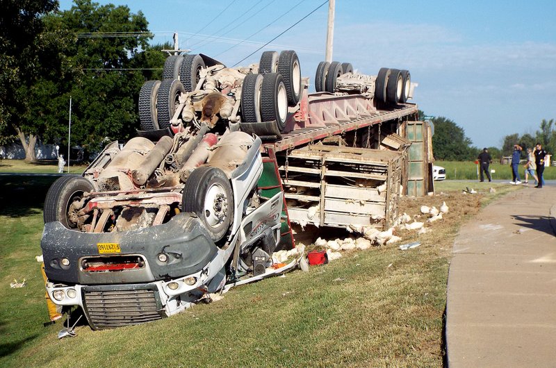 An eastbound Georges' Inc. truck loaded with cages of chickens overturned on a sharp curve on Arkansas Highway 12 at the intersection of Pioneer Lane in Gentry about 8:30 Thursday morning. No serious injuries were reported but cleanup took until mid afternoon.