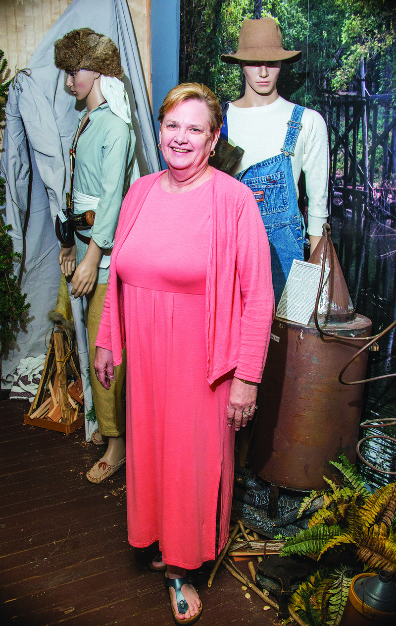 Gloriaann Sanders, executive director of the Calico Rock Museum Foundation & Visitor Center, stands by the display of mountain men as the museum prepares for its annual Mountain Man Rendezvous and Native American event, which takes place Sept. 9 and 10 at Rand Park.