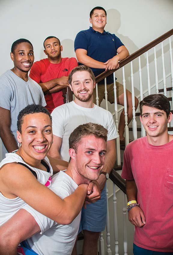 DeAsia Romes of Conway, who has cerebral palsy, gets a piggyback ride from Benjy Richards in the Sigma Sigma Sigma sorority house at the University of Central Arkansas. Richards and five other members of the Phi Gamma Delta fraternity took turns carrying her up Pinnacle Mountain in Little Rock. Also pictured are, descending from top of stairs, Cesar Ramirez, Corey Pillow, Steven Bowen, Landon Beard and Hayden Murry. The young men say they are planning to take Romes on other hikes, too.