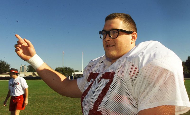 Arkansas’ Brandon Burlsworth tells a story to teammates before the beginning of practice at Thunder Field on Dec. 30, 1998, near the Citrus Bowl in Orlando.