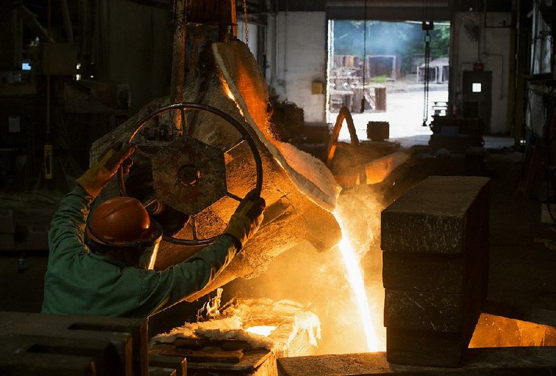 A worker pours molten metal into a large ladle at the Quaker City Castings facility in Salem, Ohio, on Wednesday. Orders to U.S. factories for manufactured goods rose 4.4 percent in July.