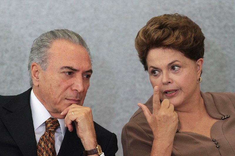 In this April 24, 2012 file photo, Brazil's President Dilma Rousseff, right, talks with Vice President Michel Temer, during a ceremony at Planalto Palace in Brasilia, Brazil. 