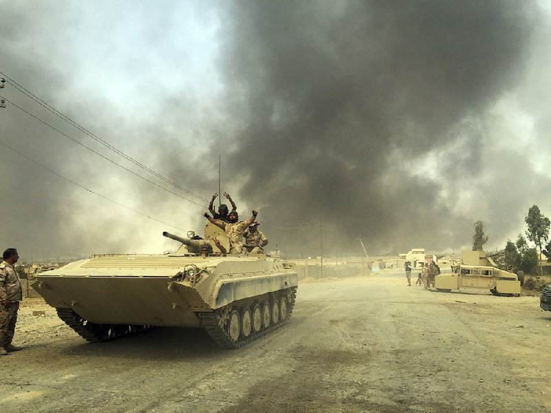 Iraqi forces enter the town of Qayara after defeating Islamic State militants there Thursday.