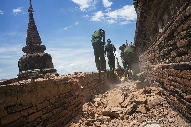 Burmese soldiers clear debris Thursday at a temple damaged in Wednesday’s magnitude-6.8 earthquake.
