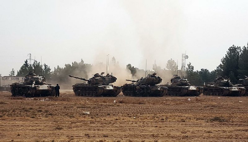 Turkish tanks take position Thursday in Karkamis near the Syrian border after a U.S.-backed offensive by Kurdish militias and Syrian rebels recaptured the border town of Jarablus on Wednesday.