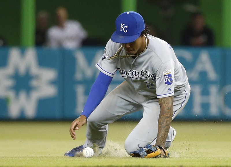 Kansas City Royals second baseman Raul Mondesi attempts to grab a ball hit by Miami Marlins' Adeiny Hechavarria during the fourth inning of a baseball game, Thursday, Aug. 25, 2016, in Miami. Hechavarria ended up with a single. 