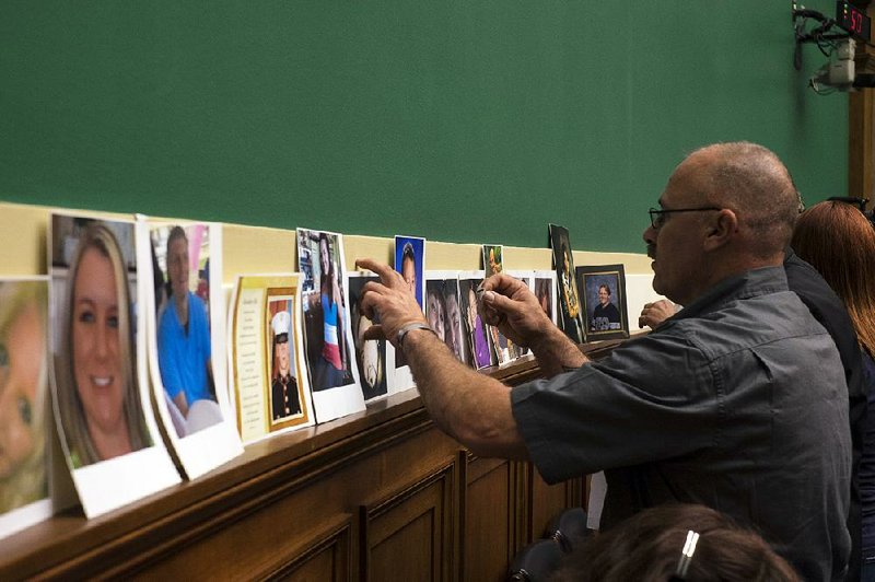 During a House committee hearing in 2014, relatives line up photos of people killed in accidents possibly caused by defective ignition switches in General Motors vehicles. 