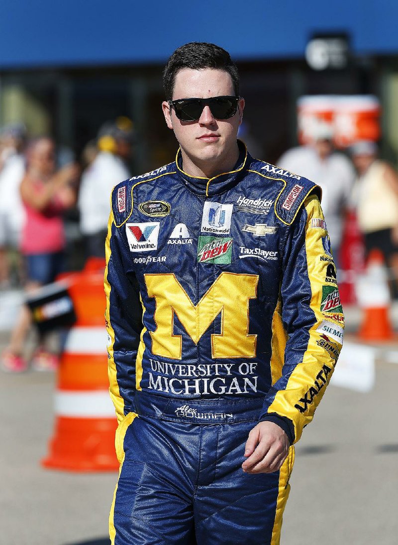 Alex Bowman walks along pit lane before qualifications for the NASCAR Sprint Cup Series auto race at Michigan International Speedway in Brooklyn, Mich., Friday, Aug. 26, 2016.  