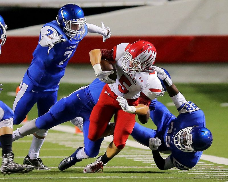 Vilonia running back Cody Mitchell (center) is brought down by several Sylvan Hills defenders during a game last season. The Bears return fi ve defensive starters from a team that finished 6-4 and gave up nearly 29 points per game in 2015.