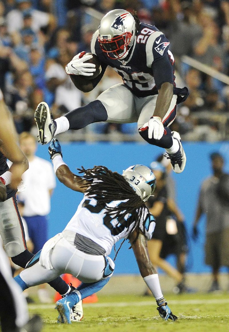 New England Patriots running back LeGarrette Blount (29) leaps over Carolina Panthers defensive back Tre Boston during Friday night’s exhibition game in Charlotte, N.C.