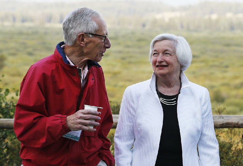 Stanley Fischer, Federal Reserve vice chairman, talks Friday with Fed Chairman Janet Yellen at the central bankers’ conference near Jackson Hole, Wyo. 