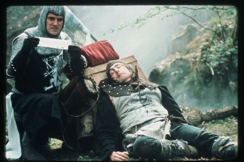 John Cleese (left) and Eric Idle perform in a scene from Monty Python and the Holy Grail: a comedic sensibility born from the horrors of war.Democrat-Gazette file photo