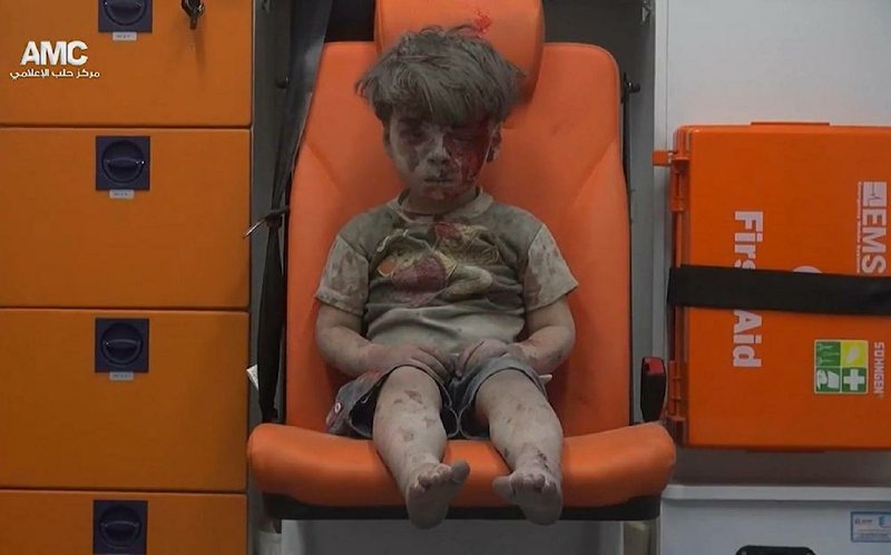 In this frame grab taken from video provided by the Syrian anti-government activist group Aleppo Media Center
(AMC), 5-year-old Omran Daqneesh sits in an ambulance after being pulled out of a building hit by an airstrike
on Aug. 17 in Aleppo, Syria.
