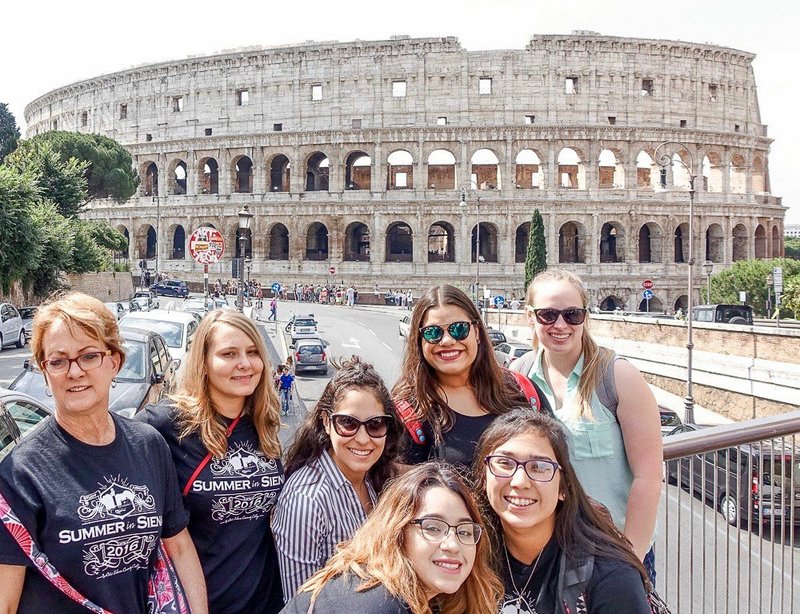 Evelyn Jorgenson (left), president of Northwest Arkansas Community College, poses with fellow travelers in front of the Colosseum in Rome during the first NWACC in Italy study abroad program this summer.